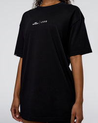 Woman wearing Movember 2025 FLXCotton Oversize Tee - Black | Model:Jordan | Size:XS