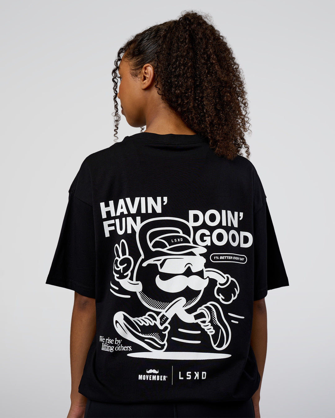 Woman wearing Movember 2025 FLXCotton Oversize Tee - Black | Model:Jordan | Size:XS