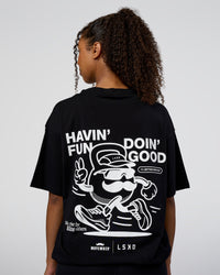 Woman wearing Movember 2025 FLXCotton Oversize Tee - Black | Model:Jordan | Size:XS