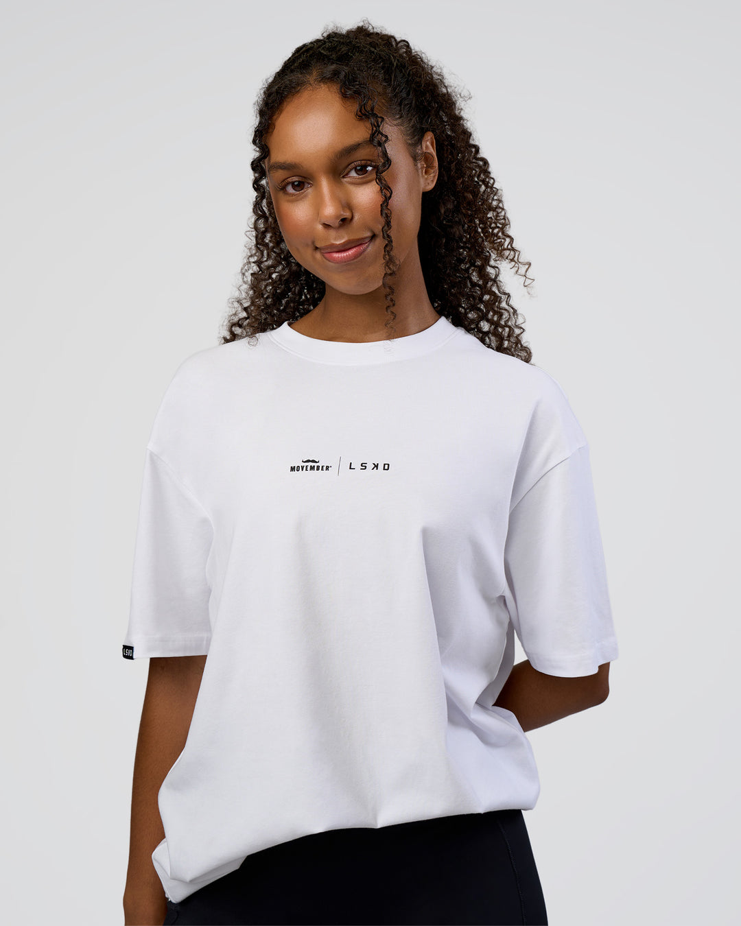 Woman wearing Movember 2025 FLXCotton Oversize Tee - White | Model:Jordan | Size:XS