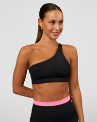 Woman wearing Muse Asymmetric Sports bra - Black | Model:Brylee | Size:XS