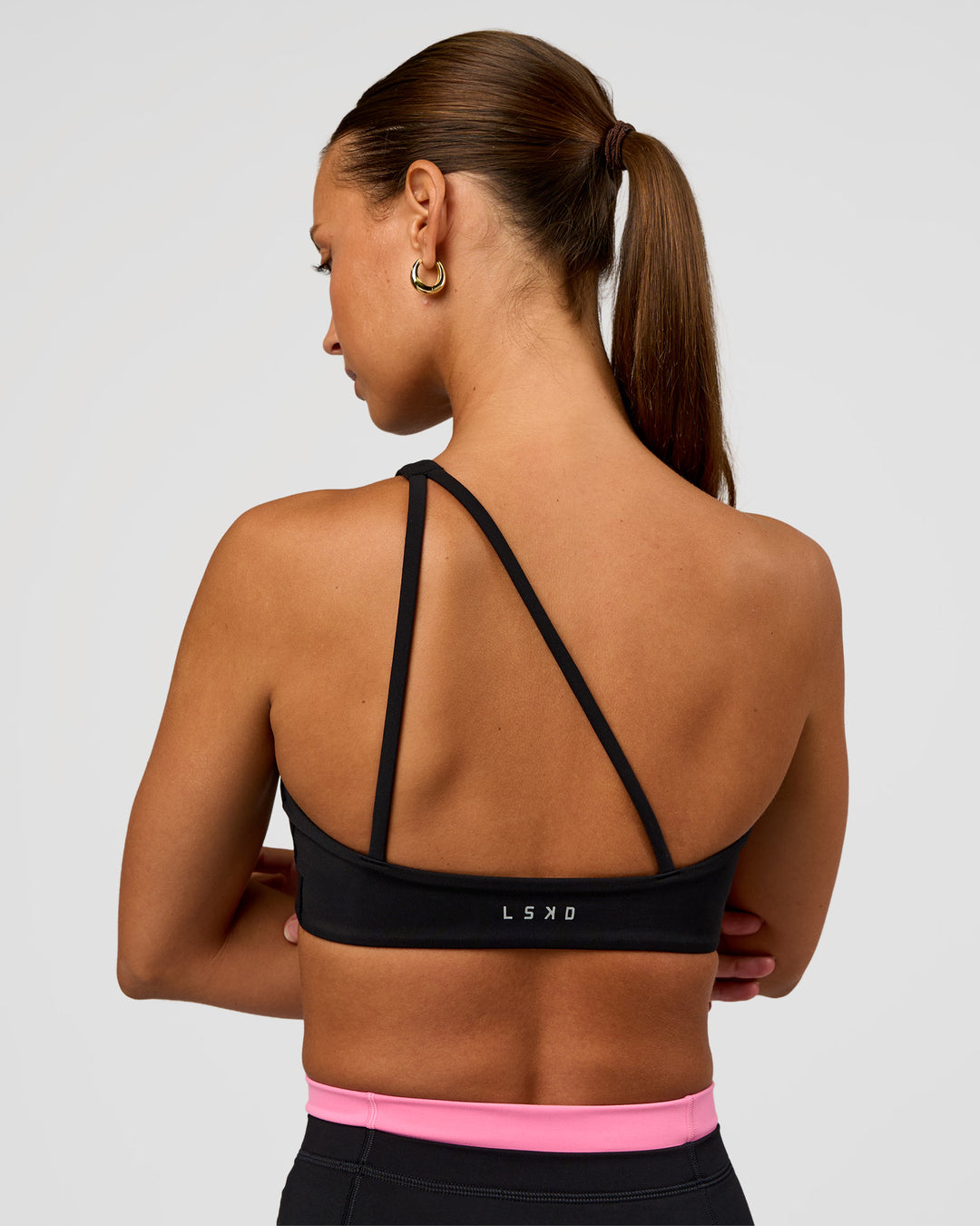 Woman wearing Muse Asymmetric Sports bra - Black | Model:Brylee | Size:XS