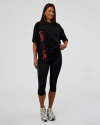 Woman wearing Nothing Is Impossible FLXCotton Oversized Tee - Black-Flame | Model:Bianca | Size:XS