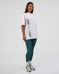 Woman wearing Nothing Is Impossible FLXCotton Oversized Tee - White-Vital Green | Model:Bianca | Size:XS