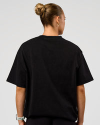Woman wearing Offset Heavyweight Unisex Oversized Tee - Black Washed-Castlerock | Model:Maja | Size:XS