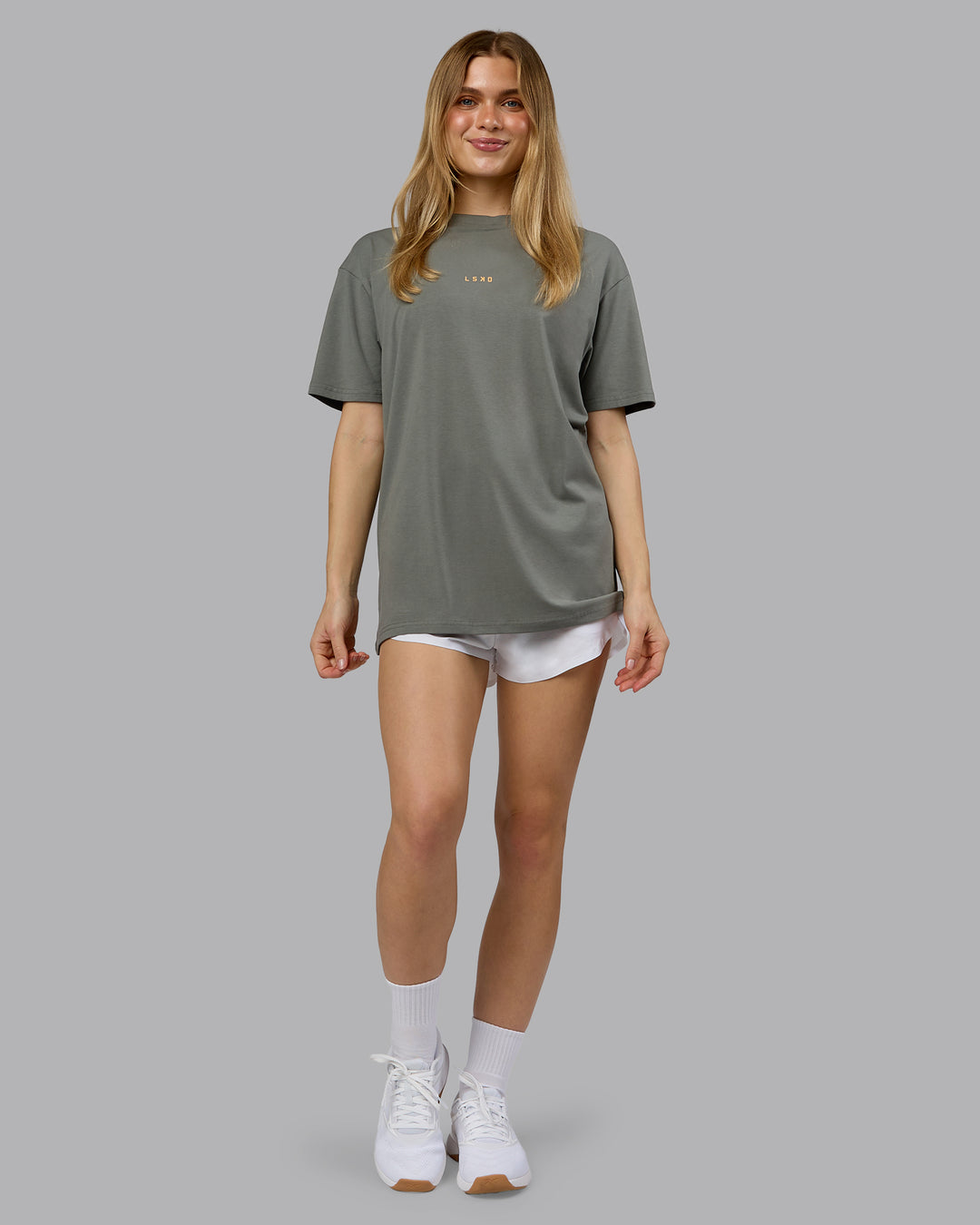 Woman wearing On Repeat FLXCotton Oversized Tee - Graphite-Warm Apricot | Model:Emilie | Size:XS