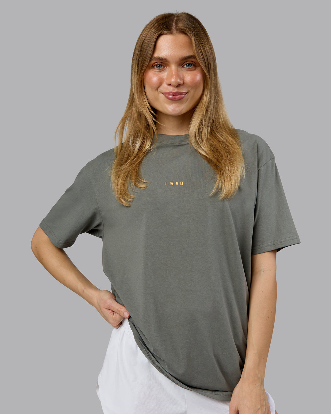 Woman wearing On Repeat FLXCotton Oversized Tee - Graphite-Warm Apricot | Model:Emilie | Size:XS