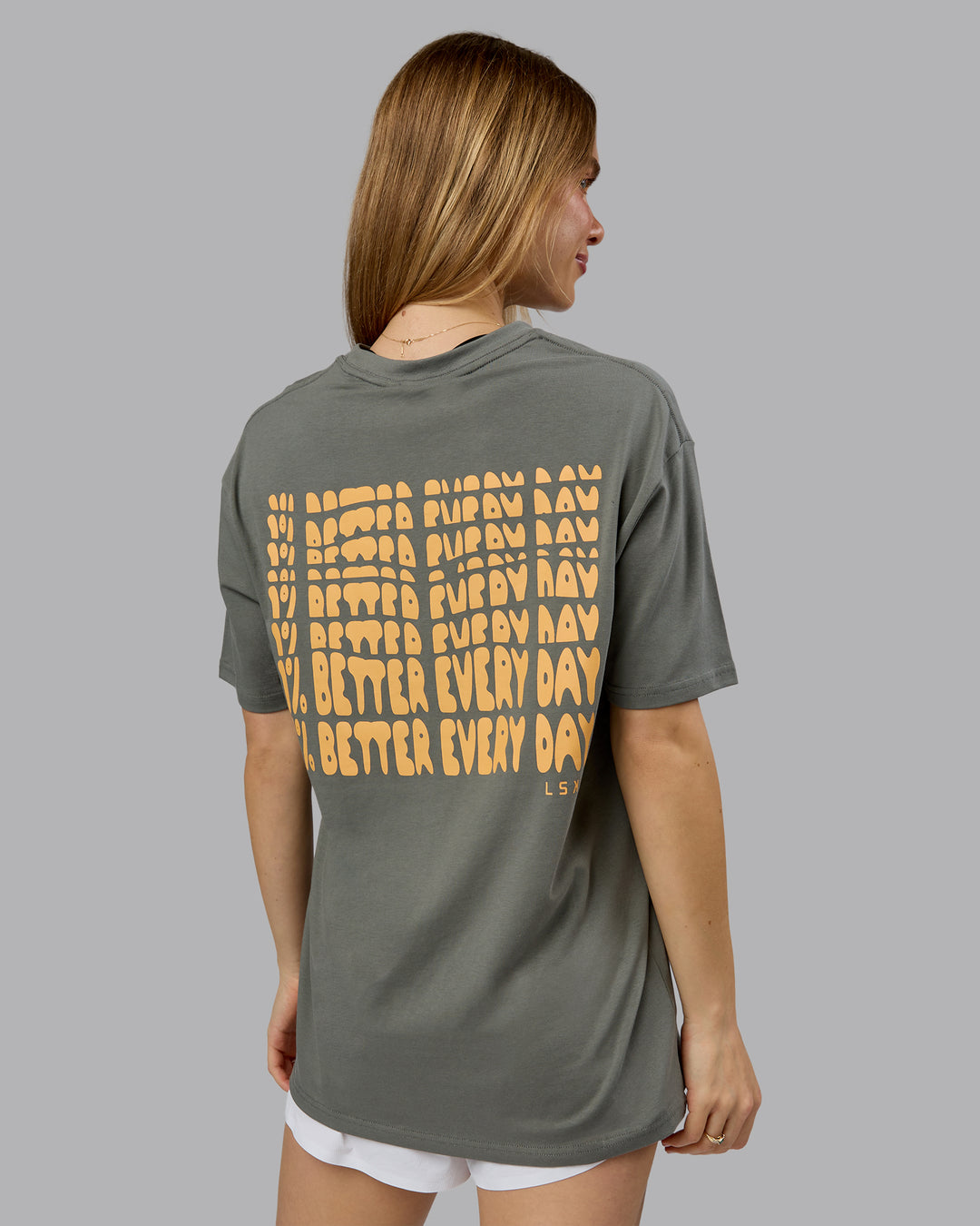 Woman wearing On Repeat FLXCotton Oversized Tee - Graphite-Warm Apricot | Model:Emilie | Size:XS