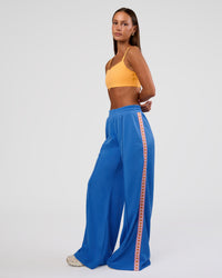 Woman wearing Peaches Track Pant - Palace Blue | Model:Brylee | Size:XS