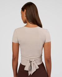 Woman wearing Peaches Wrap Cinch Top - Shale Beige | Model:Brylee | Size:XS