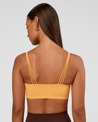 Woman wearing Peaches Wrap Sports Bra - Warm Apricot | Model:Brylee | Size:XS