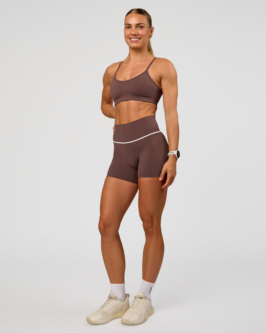 Woman wearing Pinnacle High-Rise 4" Short - Cocoa Powder-Off White | Model:Maja | Size:XS