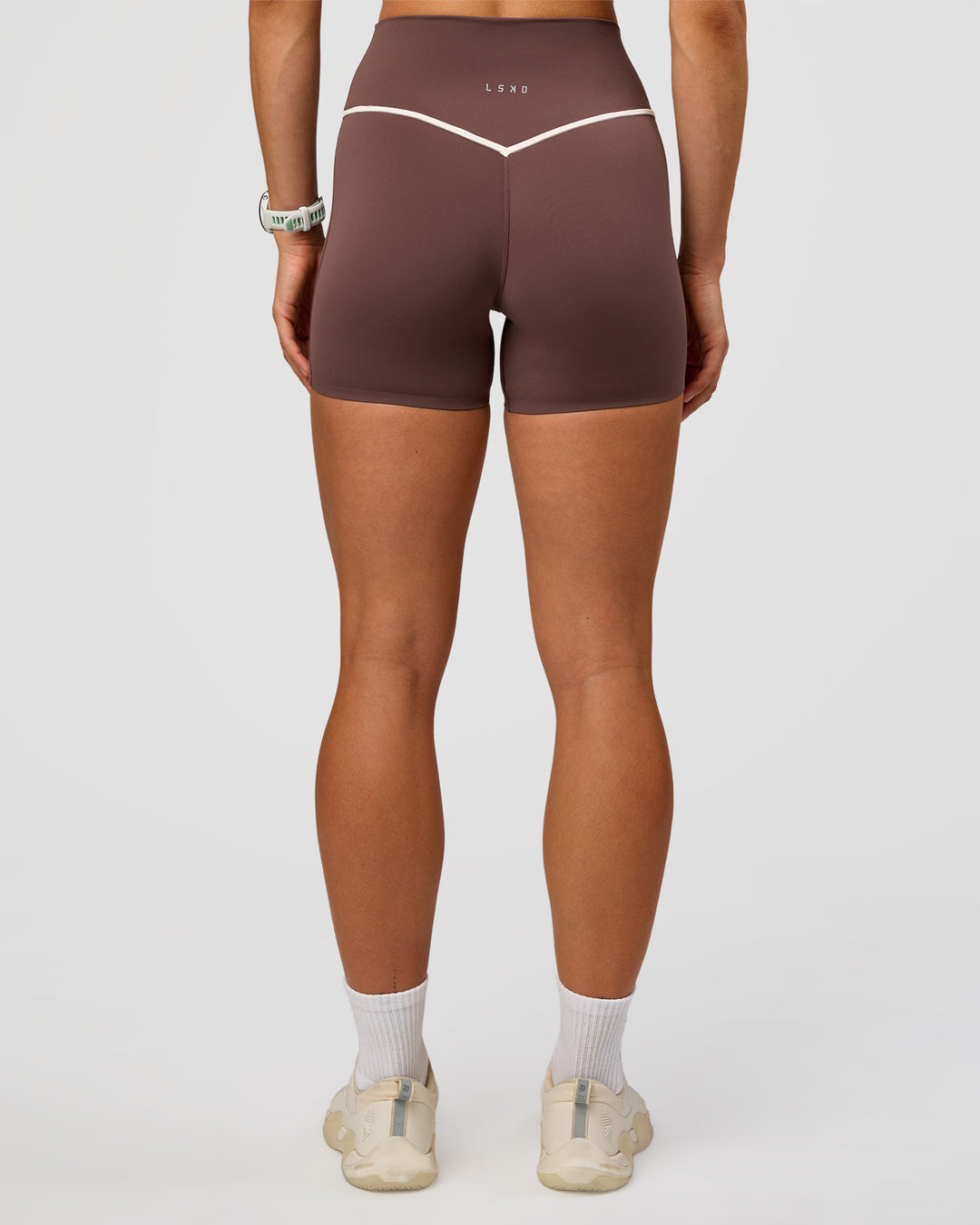 Woman wearing Pinnacle High-Rise 4" Short - Cocoa Powder-Off White | Model:Maja | Size:XS