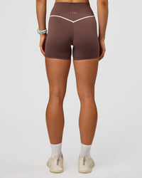 Woman wearing Pinnacle High-Rise 4" Short - Cocoa Powder-Off White | Model:Maja | Size:XS