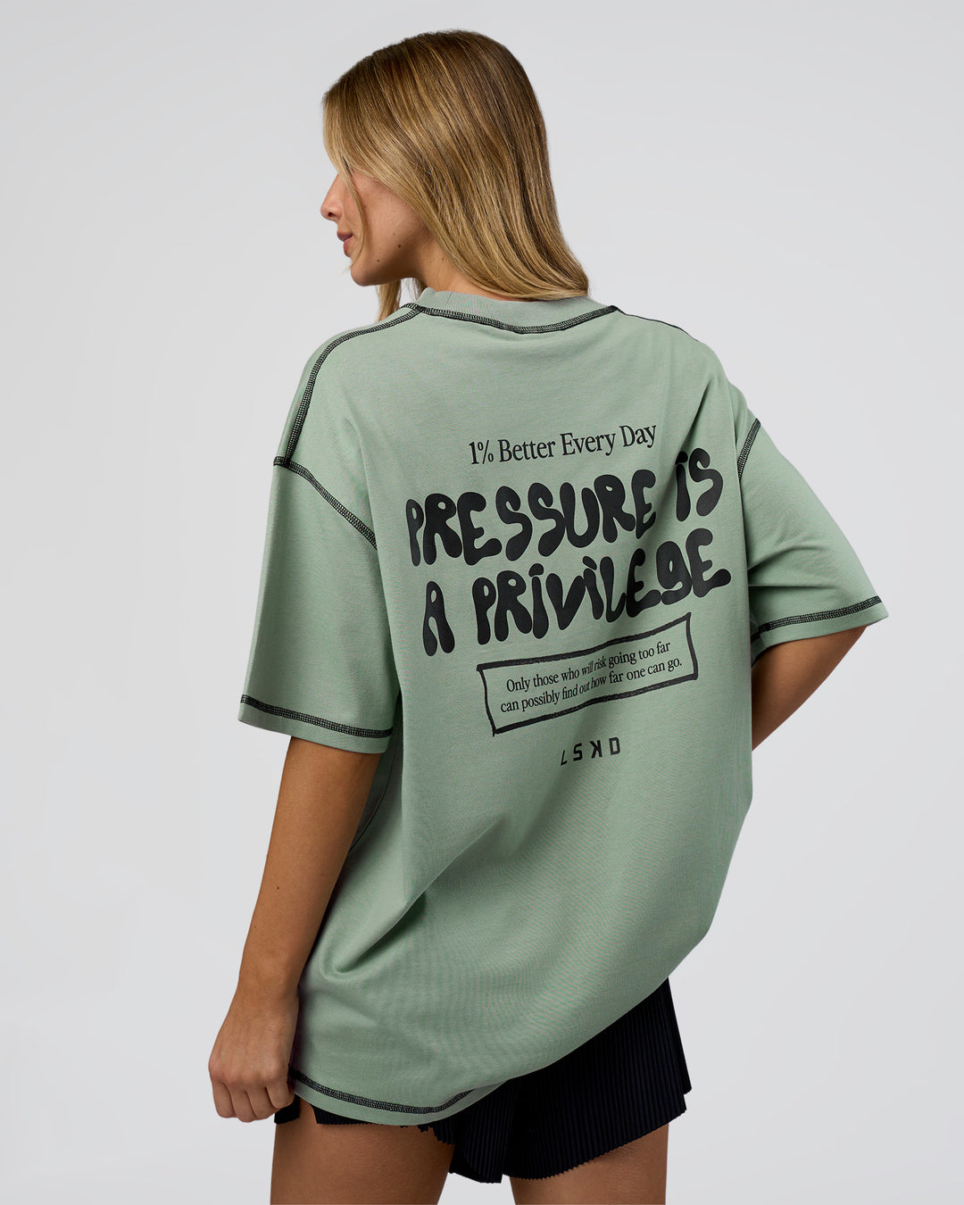 Woman wearing Pressure is Privilege Oversized Tee - Iceberg Green-Black | Model:Leilani | Size:XS