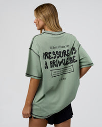 Woman wearing Pressure is Privilege Oversized Tee - Iceberg Green-Black | Model:Leilani | Size:XS