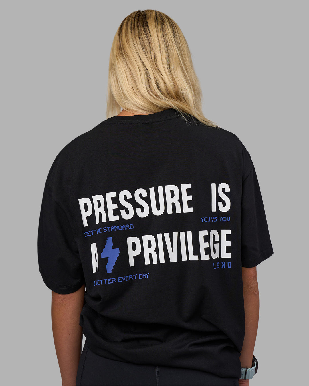 Woman wearing Pressure is a Privilege FLXCotton Oversized Tee - Black-Power Cobalt | Model:Alex | Size:XS