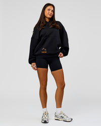Woman wearing Pride Sticker Boxy Hoodie - Black | Model:Bianca | Size:XS