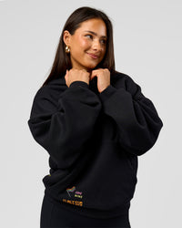 Woman wearing Pride Sticker Boxy Hoodie - Black | Model:Bianca | Size:XS