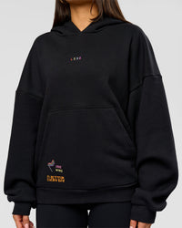 Woman wearing Pride Sticker Boxy Hoodie - Black | Model:Bianca | Size:XS
