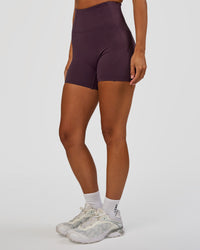 Woman wearing Progression Ultra High-Rise 4" Short - Midnight Plum | Model:Brylee | Size:XS | Thumbnail Index: 0