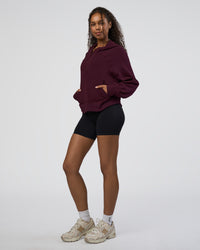 Woman wearing Pursue Mid-Weight Hoodie - Cherry Lacquer | Model:Jordan | Size:XS