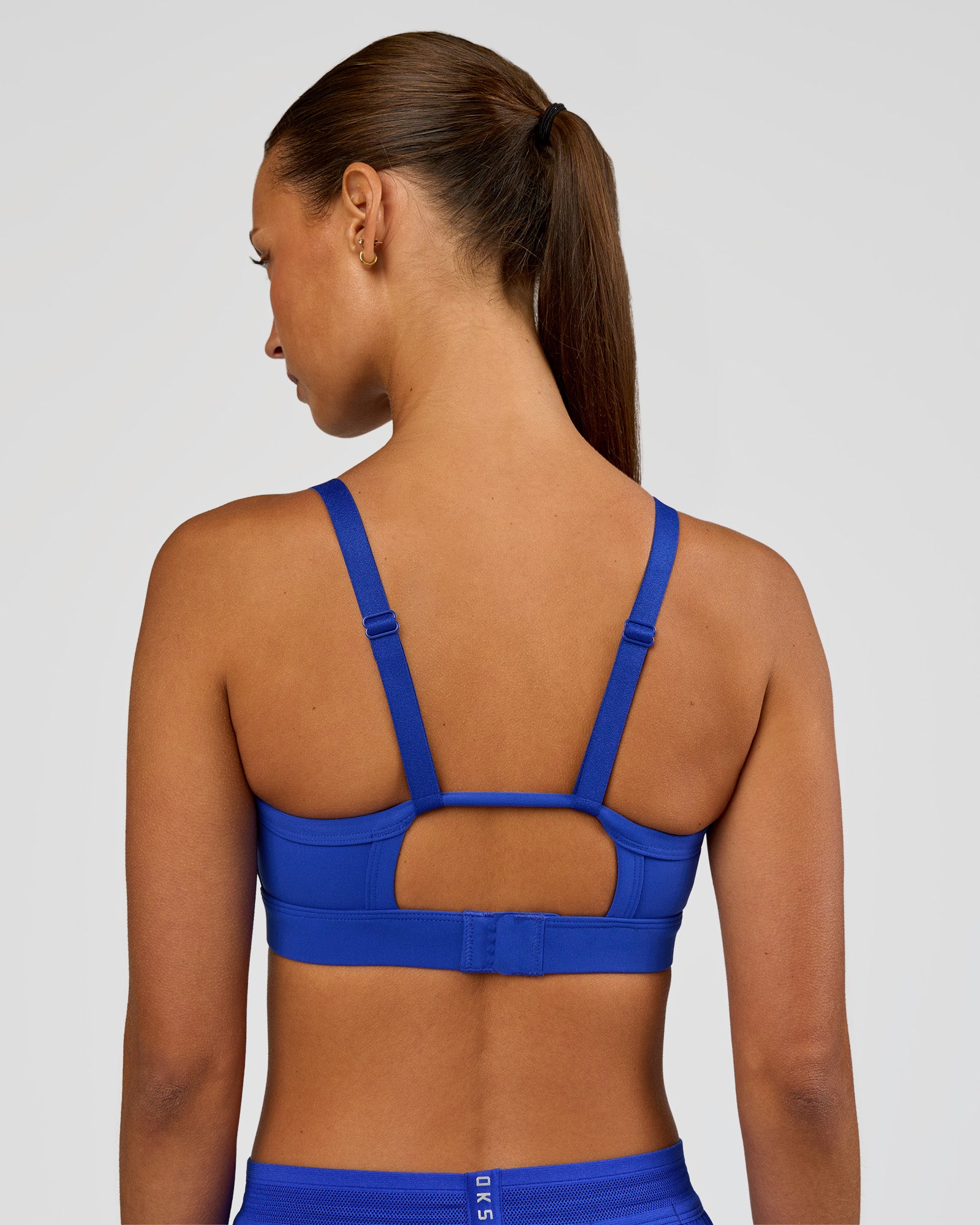 Woman wearing Rapid Sports Bra - Electric Indigo | Model:Brylee | Size:XS