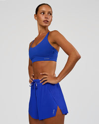 Woman wearing Rapid Sports Bra - Electric Indigo | Model:Brylee | Size:XS | Thumbnail Index: 2