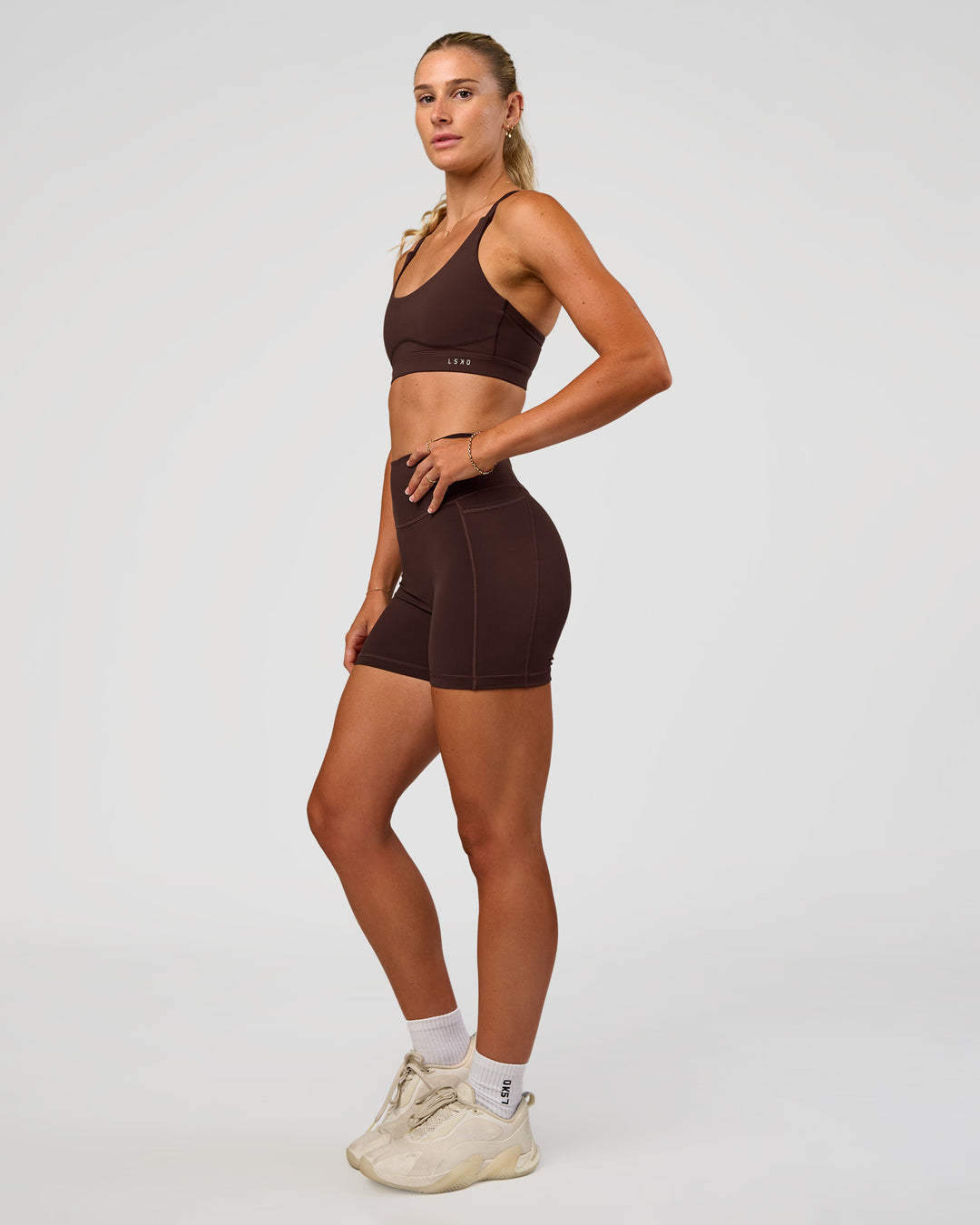 Woman wearing Rapid Sports Bra - Hot Chocolate | Model:Emelia | Size:XS