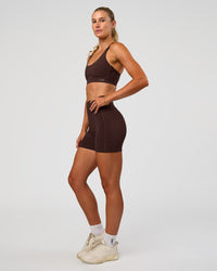 Woman wearing Rapid Sports Bra - Hot Chocolate | Model:Emelia | Size:XS