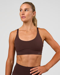 Woman wearing Rapid Sports Bra - Hot Chocolate | Model:Emelia | Size:XS