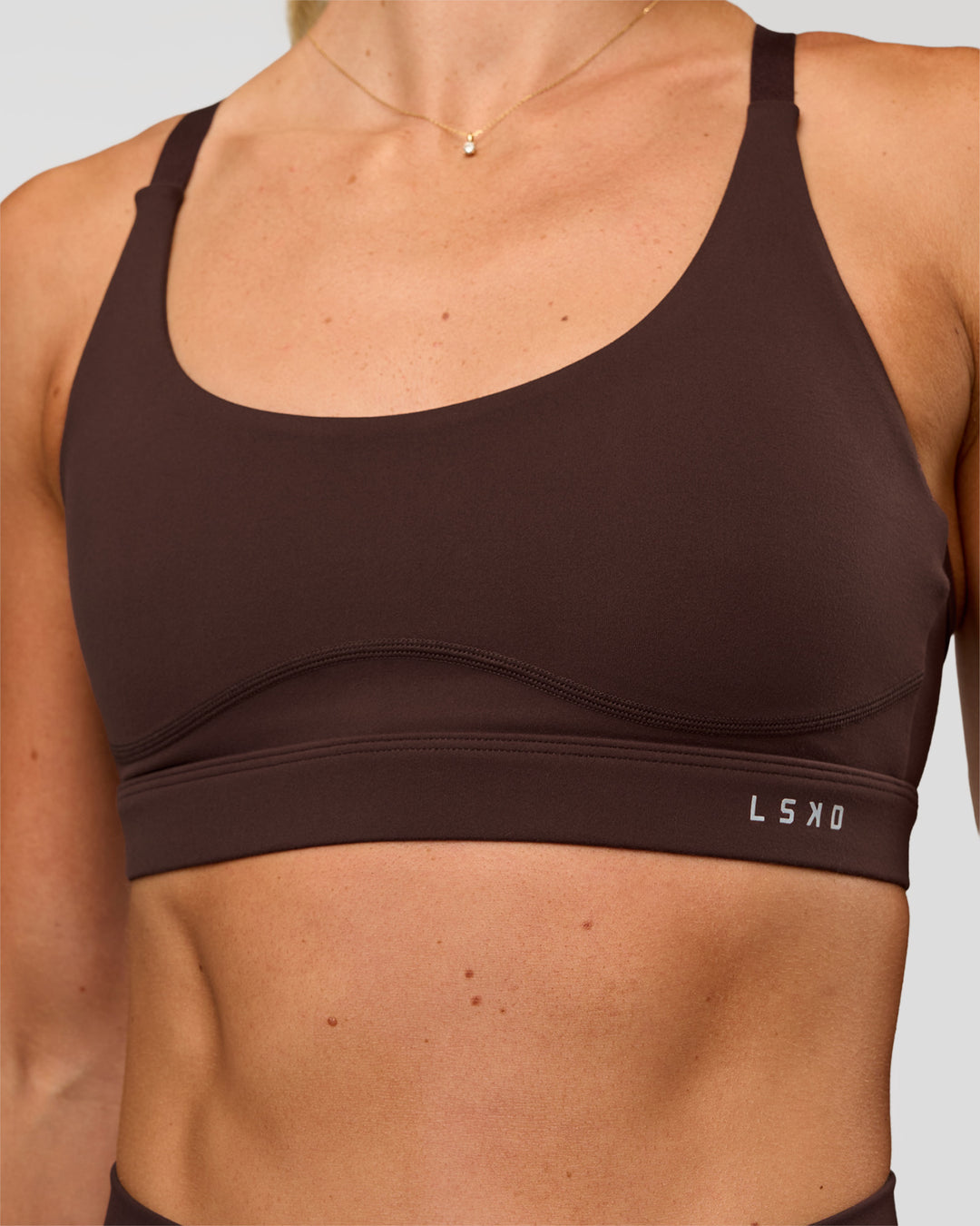Woman wearing Rapid Sports Bra - Hot Chocolate | Model:Emelia | Size:XS