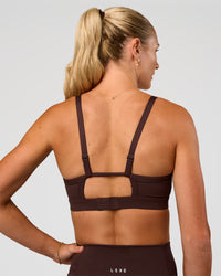 Woman wearing Rapid Sports Bra - Hot Chocolate | Model:Emelia | Size:XS