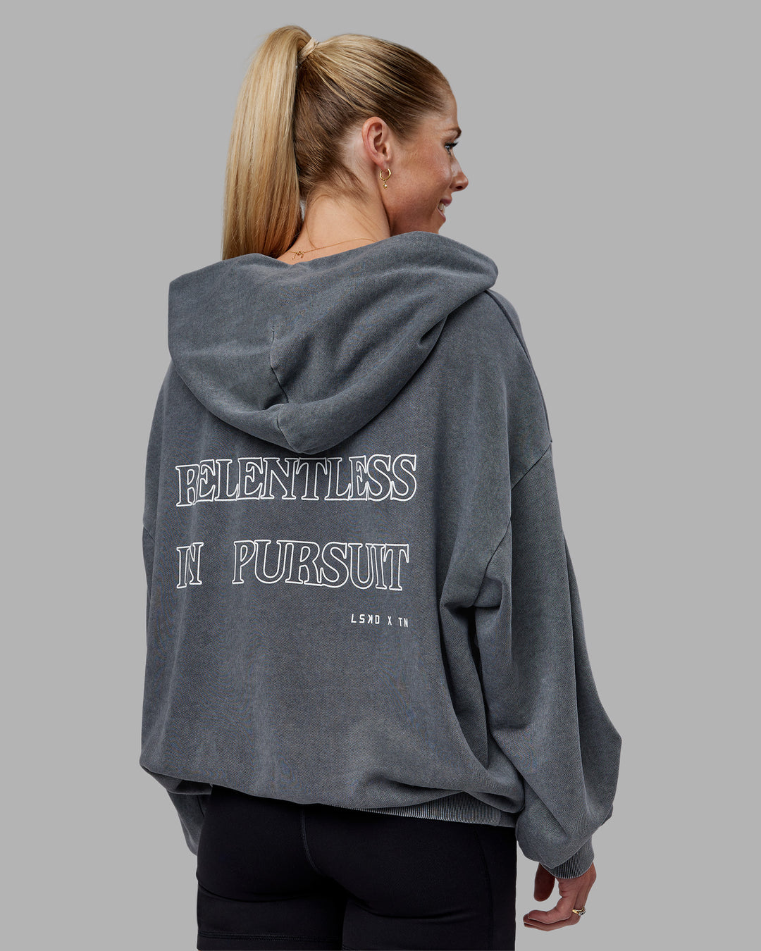 Woman wearing Relentless Washed Zip Through Oversized Hoodie - Dark Storm-White | Model:Kayti | Size:XS