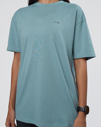 Woman wearing Research Department FLXCotton Oversized Tee - Smoke Blue | Model:Rhiley | Size:XS