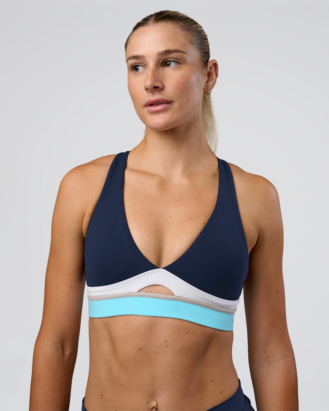 Woman wearing Revitalise Flash Sports Bra - Future Navy-Multi | Model:Emelia | Size:XS