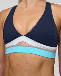 Woman wearing Revitalise Flash Sports Bra - Future Navy-Multi | Model:Emelia | Size:XS