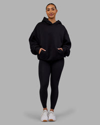 Woman wearing Rise & Lift Hoodie Oversized - Black-White | Model:Ayla | Size:XS
