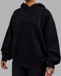 Woman wearing Rise & Lift Hoodie Oversized - Black-White | Model:Ayla | Size:XS