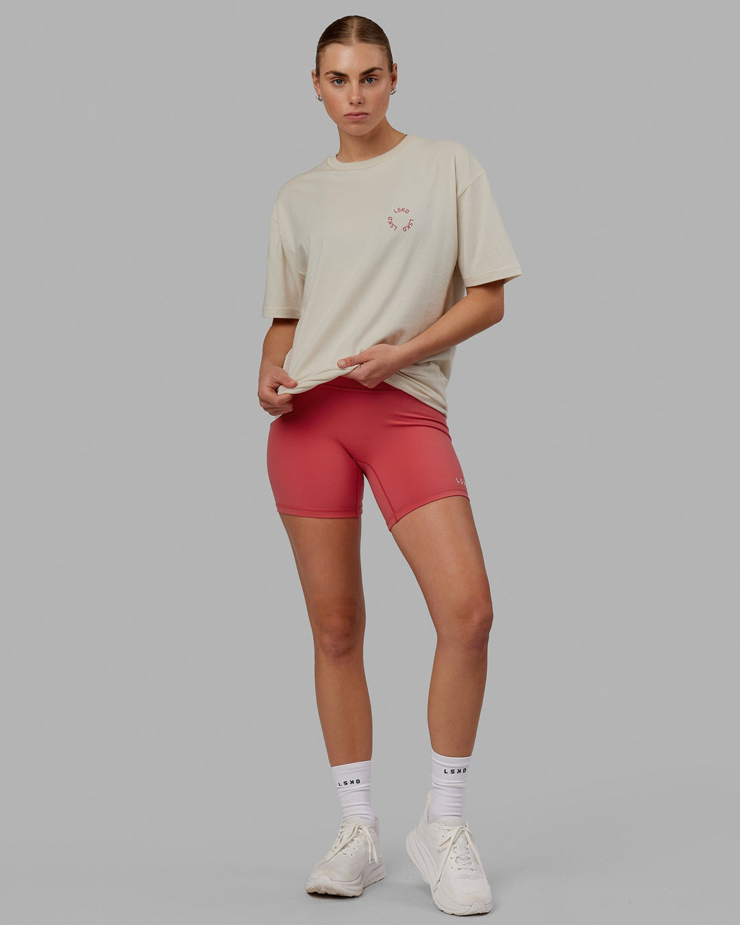 Woman wearing Unisex Rotate Tee Oversize - Bone-Mineral Red
