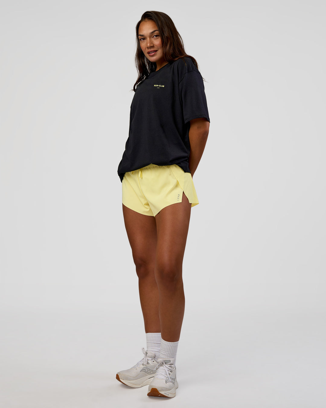 Woman wearing RUN CLUB FLXCotton Tee Oversize - Black-Yellow Fizz | Model:Kirstyn | Size:XS