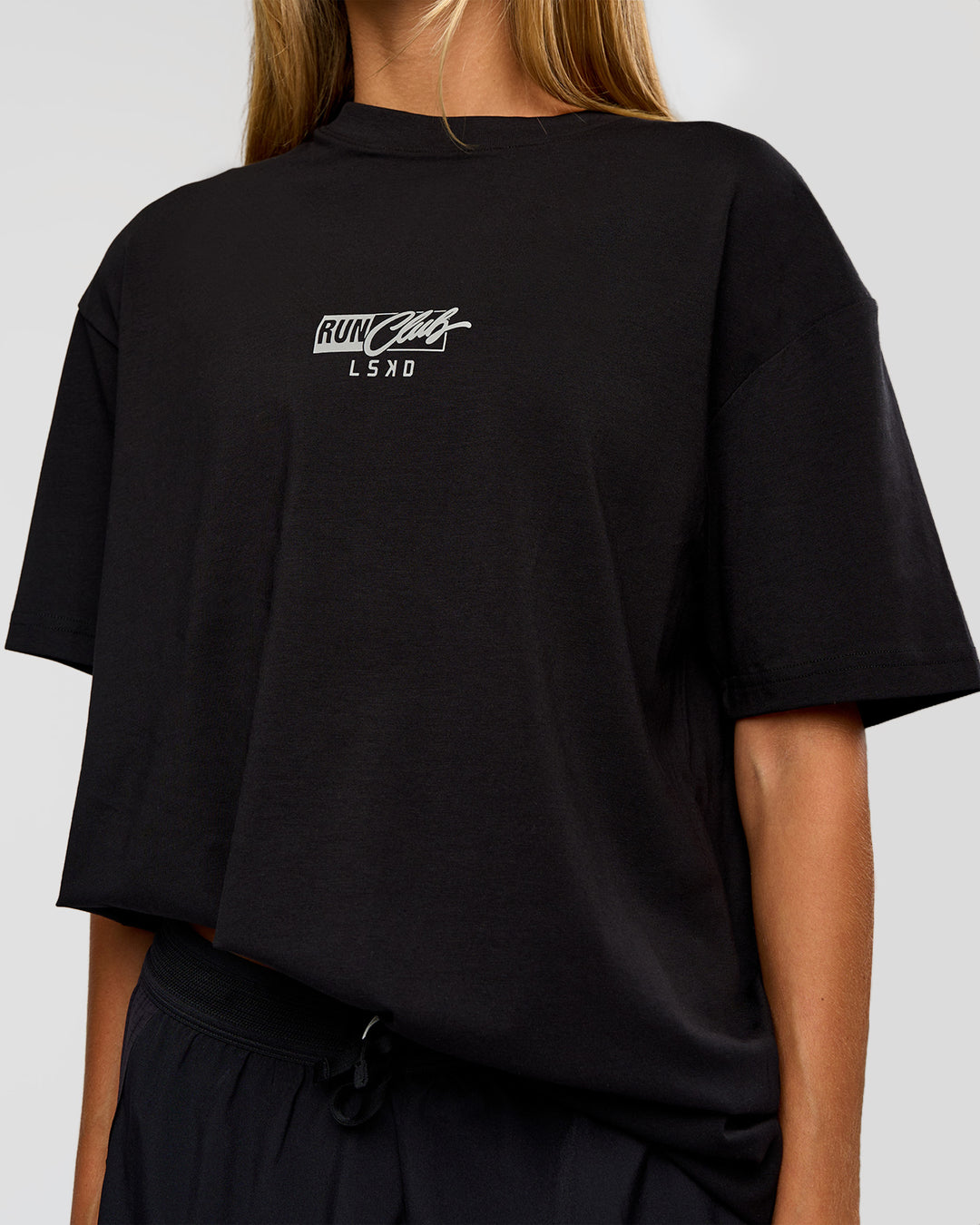 Woman wearing Run Club Script FLXCotton Oversized Tee - Black-Alloy | Model:Georgia | Size:XS