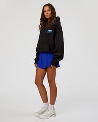 Woman wearing Run Club Script Oversized Hoodie - Black-Palace Blue | Model:Dakota | Size:XS