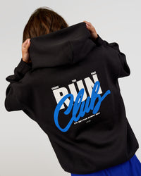 Woman wearing Run Club Script Oversized Hoodie - Black-Palace Blue | Model:Dakota | Size:XS