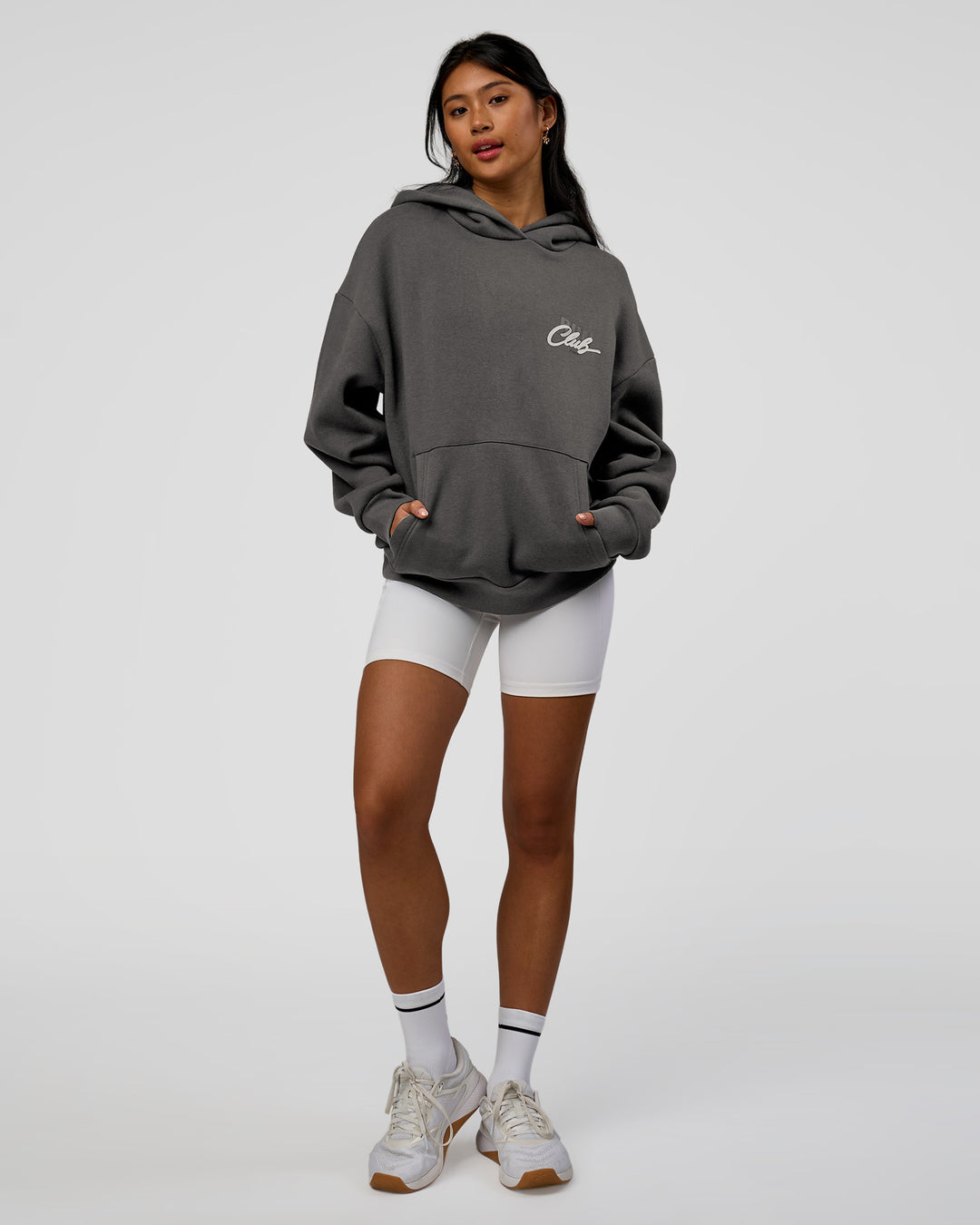 Woman wearing Run Club Script Oversized Hoodie - Dark Storm-Alloy | Model:Loren | Size:XS