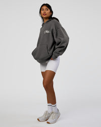 Woman wearing Run Club Script Oversized Hoodie - Dark Storm-Alloy | Model:Loren | Size:XS
