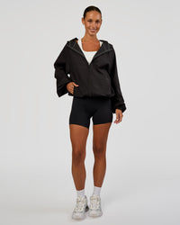 Woman wearing Run Light Jacket - Black | Model:Brylee | Size:XS