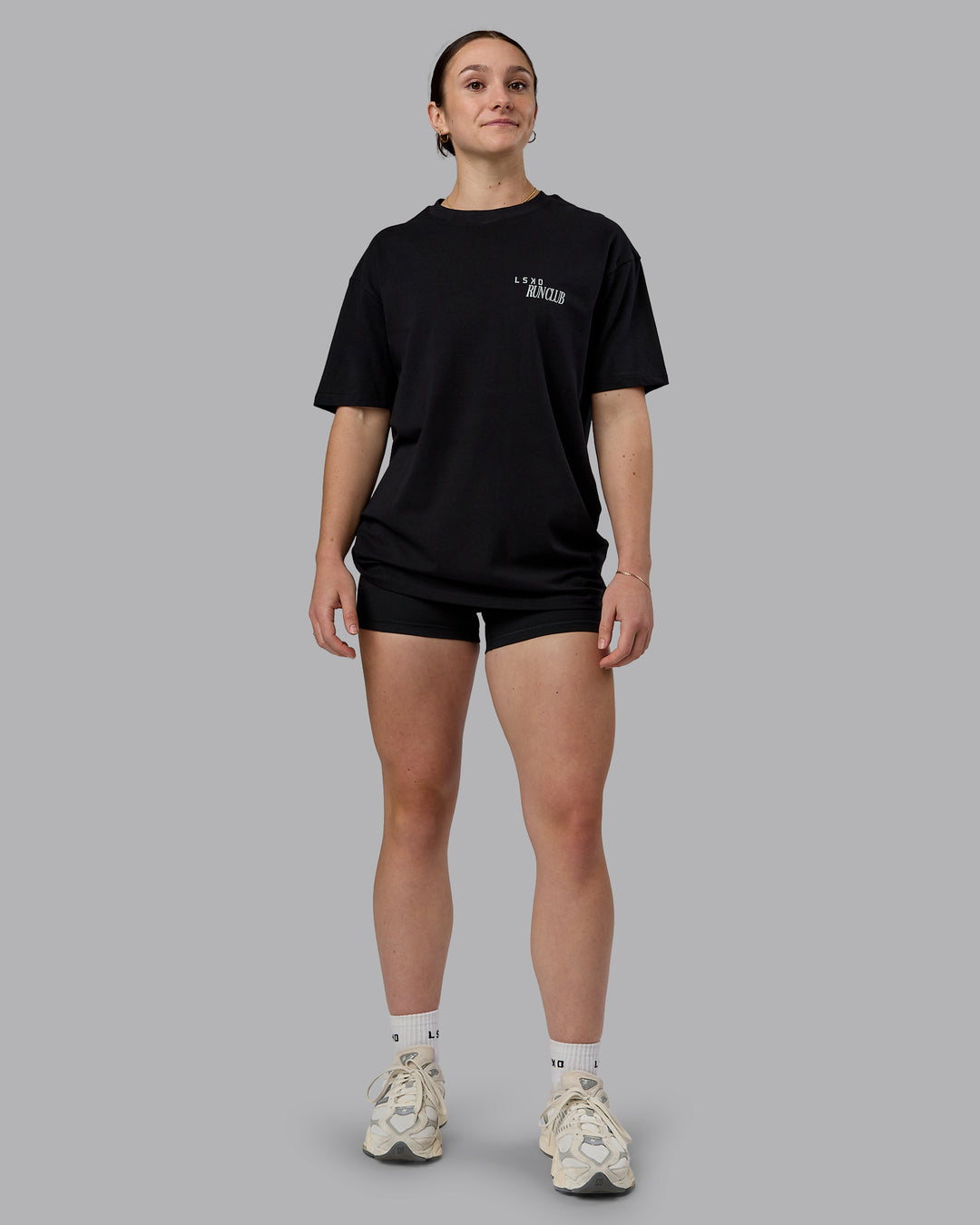 Woman wearing Run Love FLXCotton Oversized Tee - Black-Reflective | Model:Sav | Size:XS