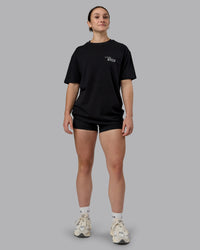 Woman wearing Run Love FLXCotton Oversized Tee - Black-Reflective | Model:Sav | Size:XS