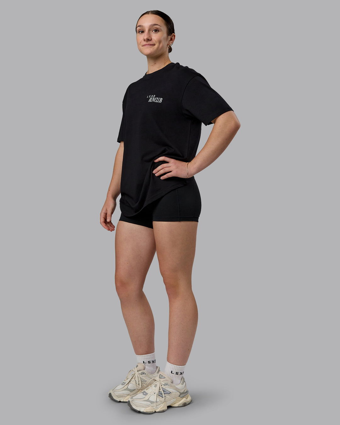 Woman wearing Run Love FLXCotton Oversized Tee - Black-Reflective | Model:Sav | Size:XS